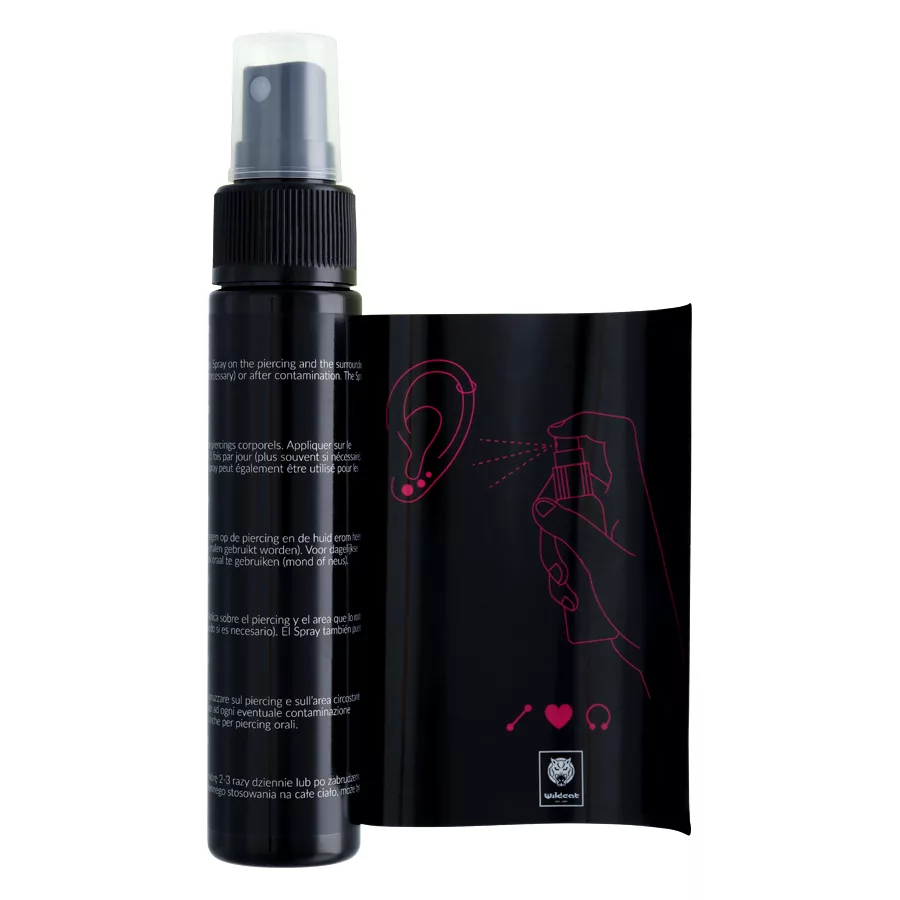 Schwarze Piercingspray Flasche und Verpackung auf weißem Hintergrund